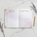 Daily planner layout spread with lavender and gold design